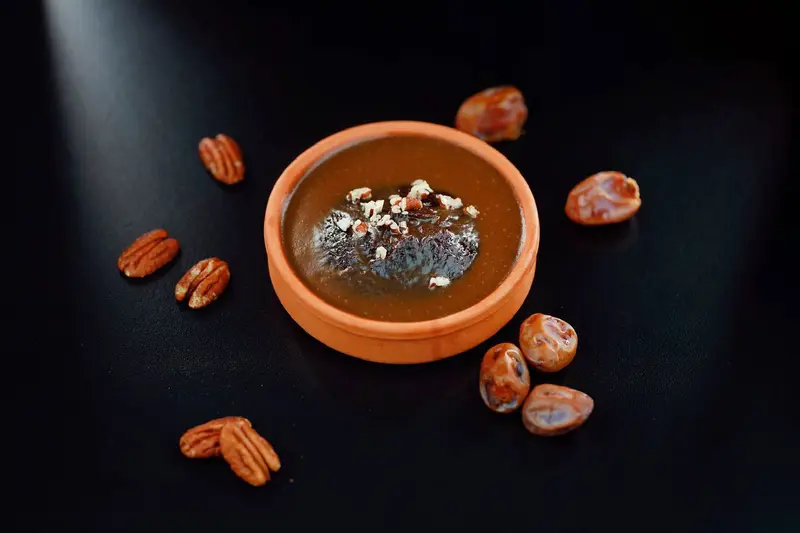 Pecans and dates in a terracotta bowl